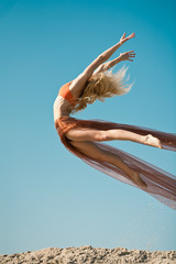 Fototapeta premium Girl dancing with big orange cloth