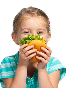 little girl eating a sandwich isolated