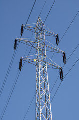 Electric power lines on a blue sky background - obrazy, fototapety, plakaty