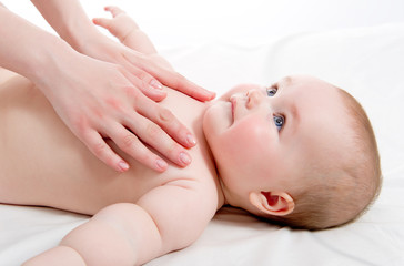 Mother massaging her lovely baby