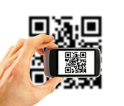 hand with mobile phone scanning QR code
