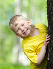 kid playing on the park tree outdoor