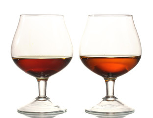 Two glasses of cognac isolated on white