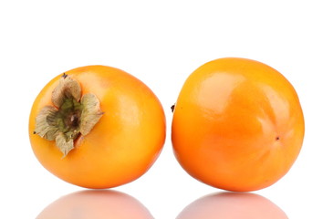 Two appetizing persimmons isolated on white