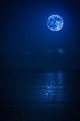 Bright full moon with reflections on the ocean
