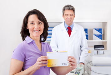 Woman buying medicine at drug store