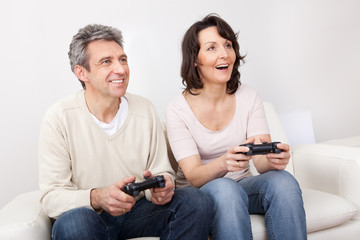 Mature couple enjoying videogames