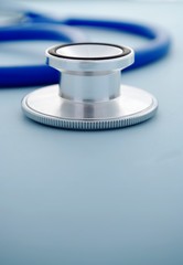 stethoscope on blue background close-up