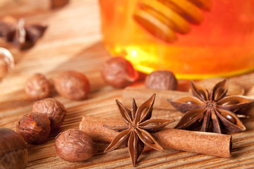 Anise stars in front of a honey jar