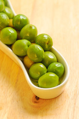 Green olives in white plate