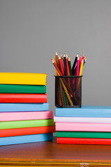 Colored pencils and a stack of books