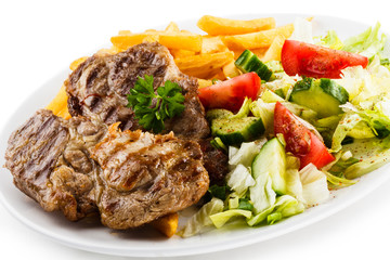 Grilled steak, French fries and vegetables