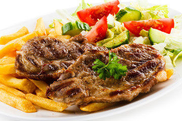 Grilled steak, French fries and vegetables