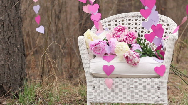 Decorations: White wicker Chair and a garland of paper hearts
