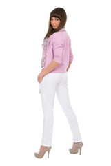 Young sexy brunette woman in pink shirt and white jeans