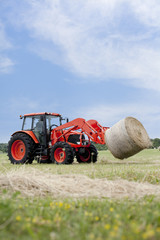 Tractor Hauling Round Bale