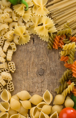 raw pasta at wood background