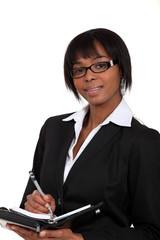 Eager businesswoman writing in her diary