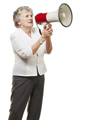 portrait of senior woman holding megaphone over white background