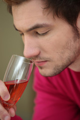Man smelling glass of wine
