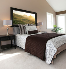 Modern brown and white bed with nightstands.