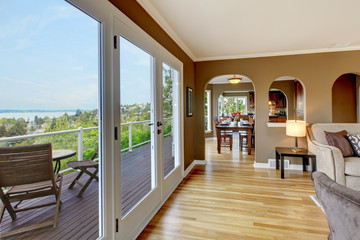 Luxury brown living room with hardwood floors.