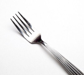 Silver fork on white background