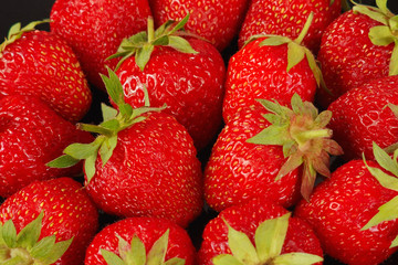 Background of the ripe fresh strawberry on black