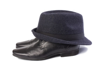 A pair of men's shoes and a classic hat