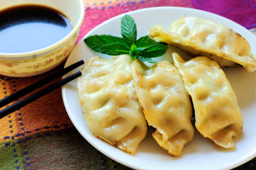 Four Chinese Gyoza, Soy Sauce, Chopsticks