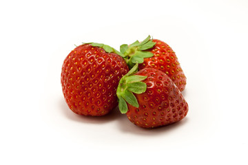 Three juicy strawberries on white background