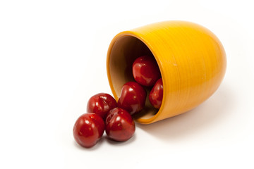 Juicy ruby red cherries in an orange cup