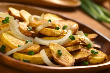 Fresh homemade crispy fried potato slices with onion