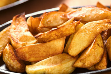 Fresh homemade crispy fried potato wedges