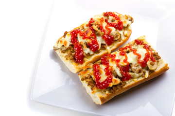 Toasted cheese and meat baguette with ketchup