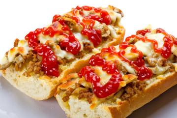 Toasted cheese and meat baguette with ketchup