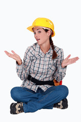 Handywoman sitting, studio shot