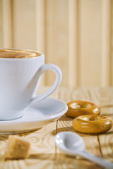 composition of the white coffee cup with spoon and bread tor, ba