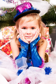A girl under the Christmas tree with gifts