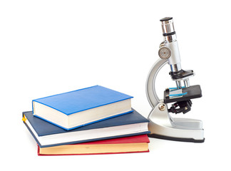 Microscope, books isolated on white