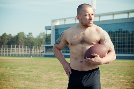 A male football player is ready to play the game