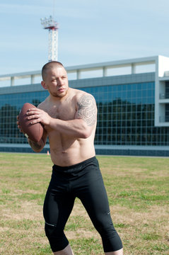Caucasian american football player just about to pass the ball