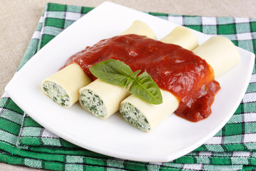 Kannelloni with spinach and ricotta under tomato sauce
