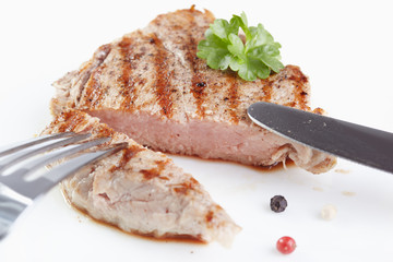 Grilled steak on white plate closeup