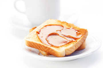 tea and toast with caramel isolated on white