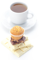 bar of chocolate,tea and muffin isolated on white