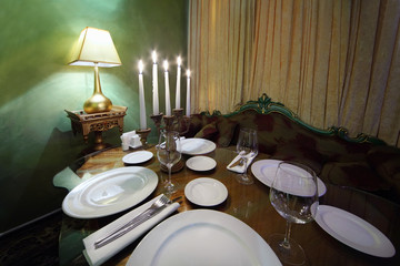 glass table with serving, lamp and beautiful sofa