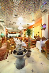eastern interior of beautiful restaurant, potted palms