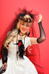laughing bride wearing black net gloves and unusual hat
