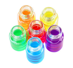 Six small opened bottles of different colored aromatic oils